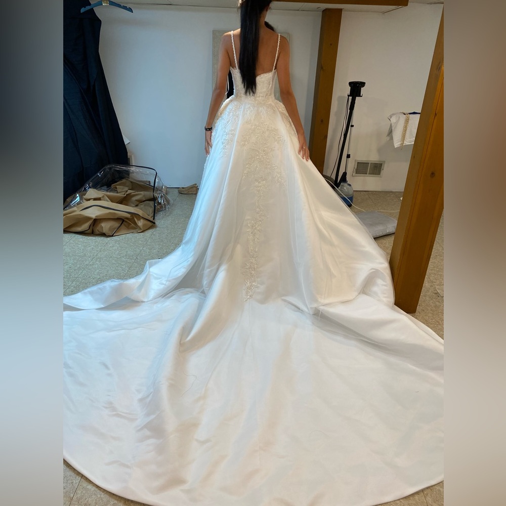 Wedding dress with detachable over skirt. Perfect condition and never worn.